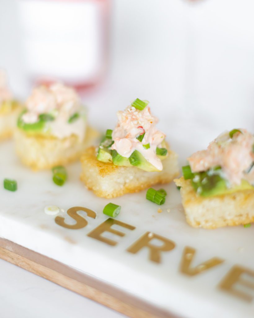 crispy rice with sweet and spicy shrimp appetizer topped with green onions