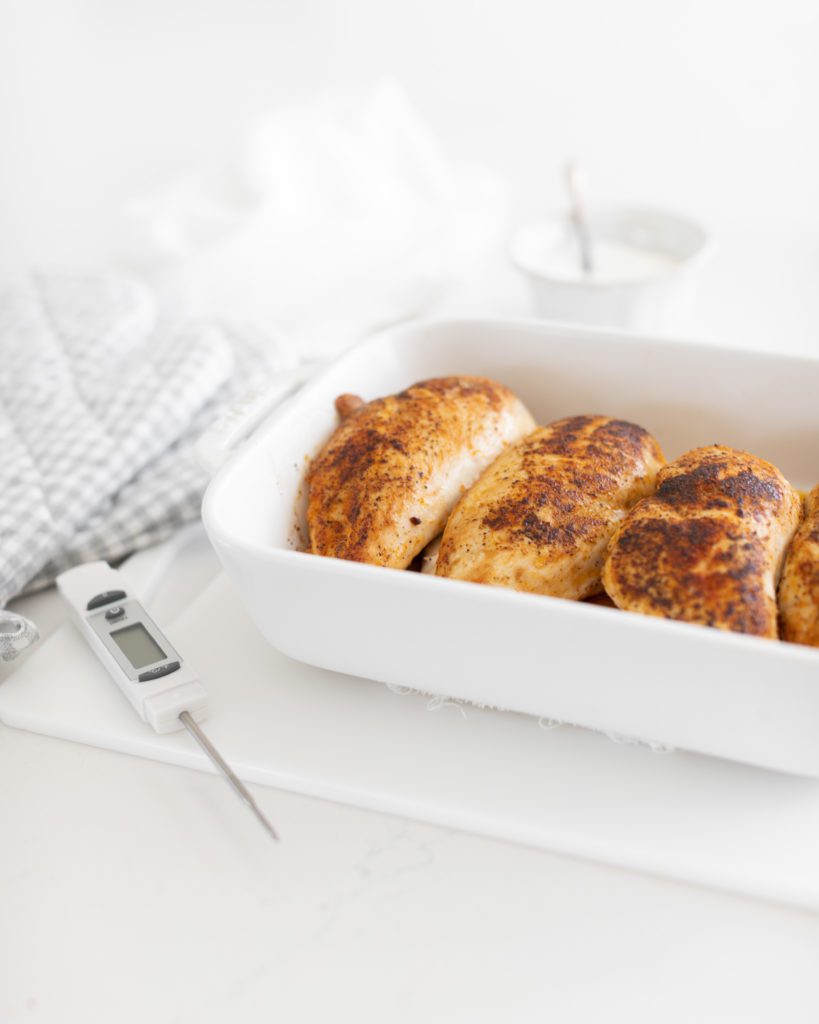 juicy chicken breasts in white baking pan