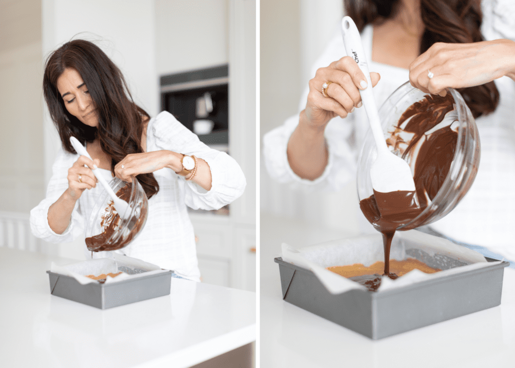 pouring chocolate layer onto Chocolate & Peanut Butter Shortbread Bars in a baking dish