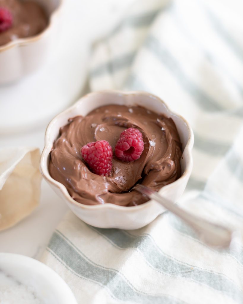 bowl of chocolate mousse with raspberries and sea salt
