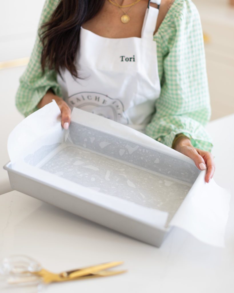 Tori lining a baking pan using her Parchment Paper Hack