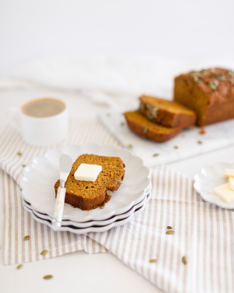 Copycat Starbucks Pumpkin Loaf  sliced on a plate with butter