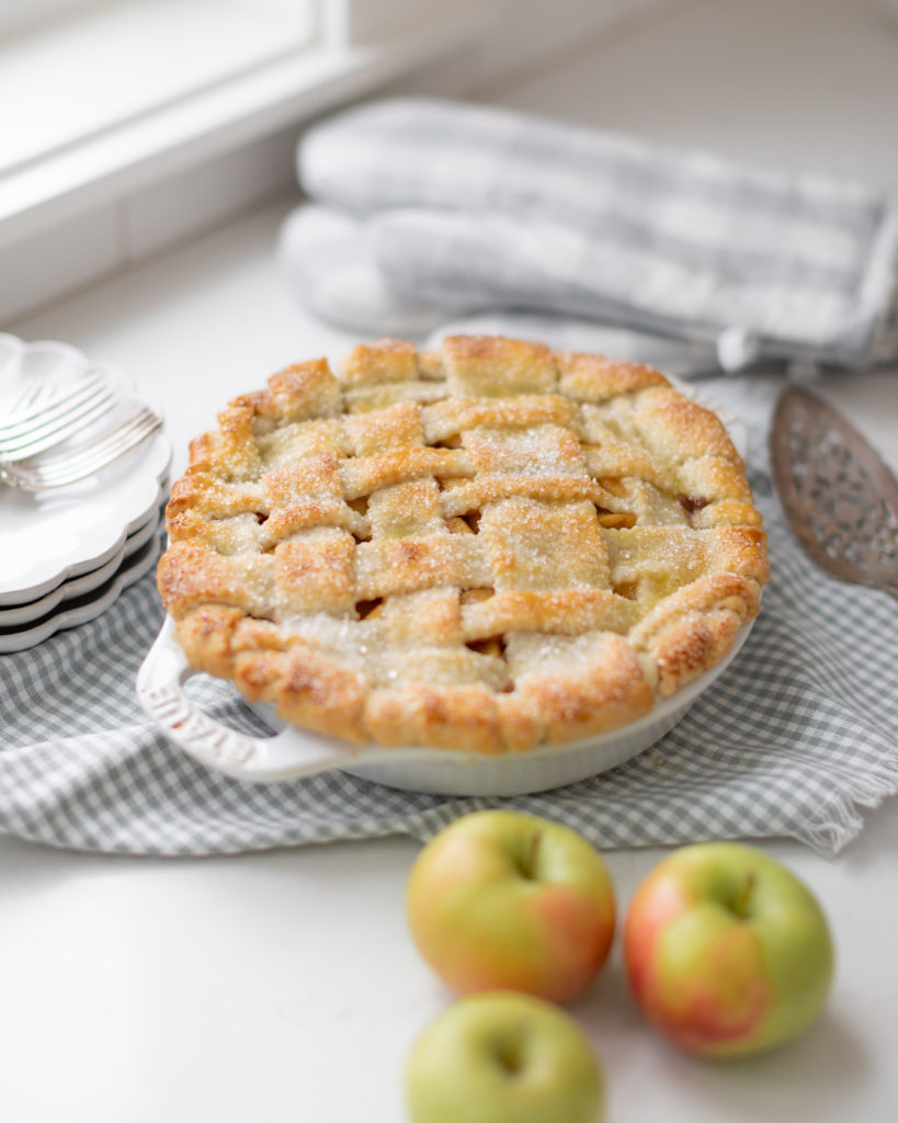 freshly baked apple pie in a white baking dish 