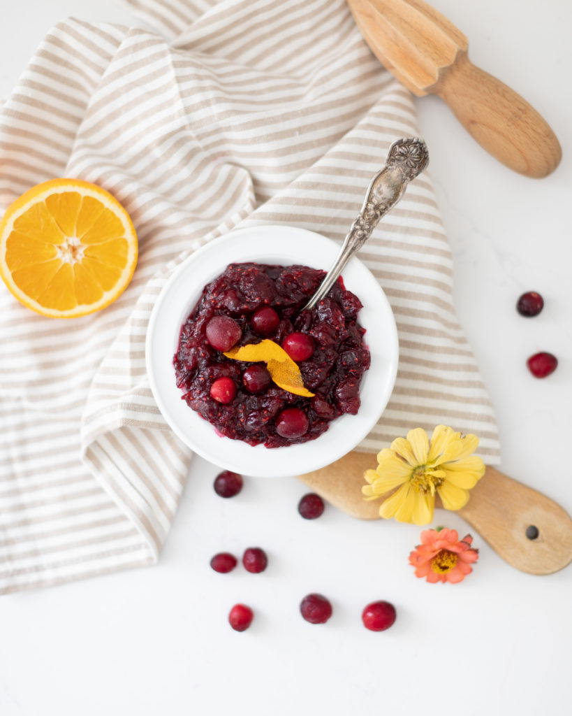 Homemade cranberry sauce in bowl with orange rind
