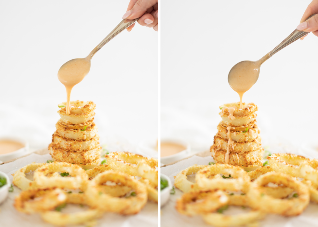 honey chipotle dipping sauce on air fryer onion rings stacked in a tall pile