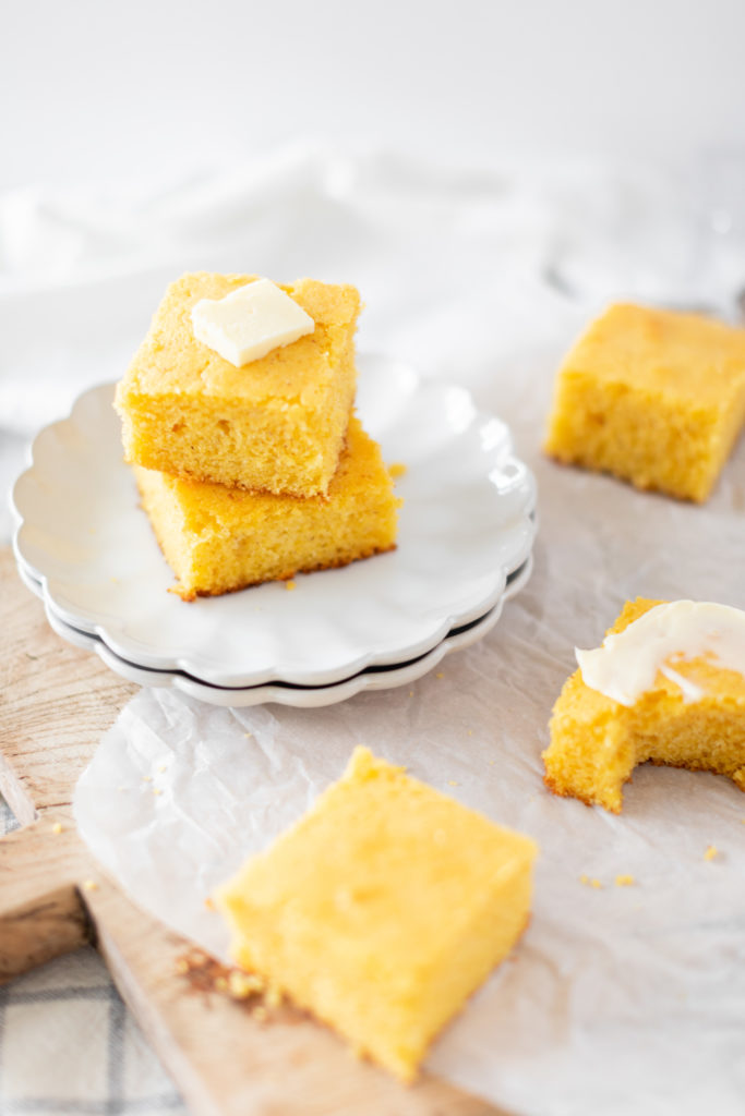 Old Fashioned Cornbread cut into squares and stacked on a plate