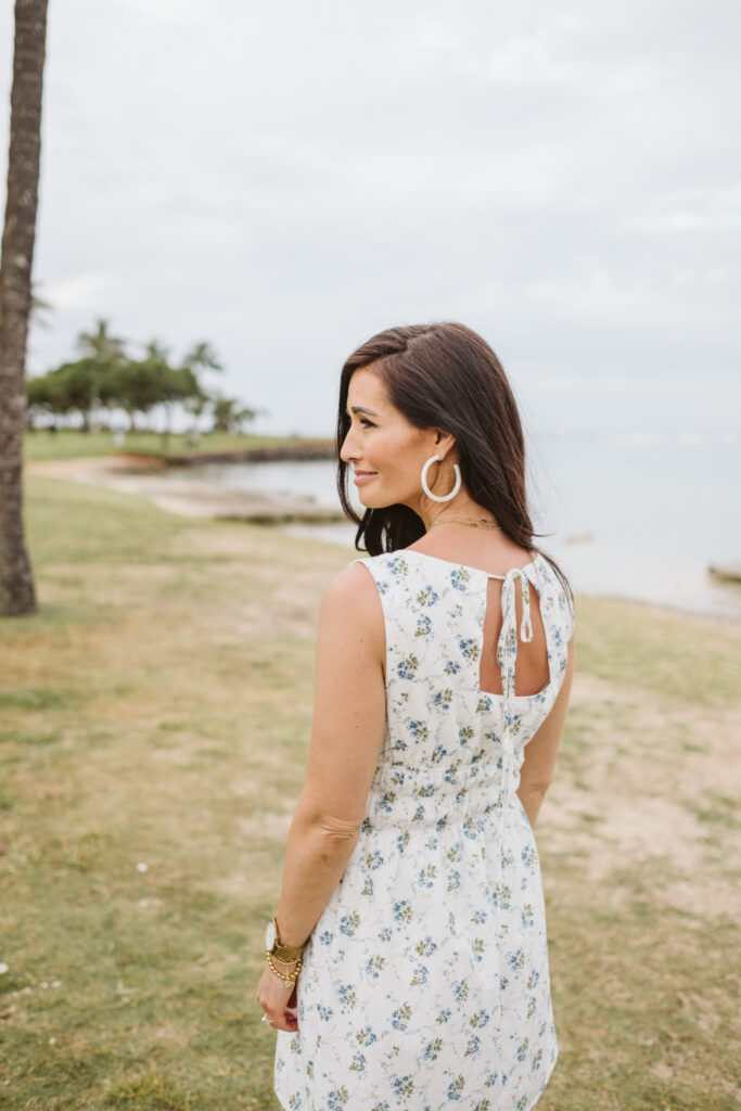 Tor showing the ppen back of her blue and white floral dress from The Fraîche x PRIV Summer Collection