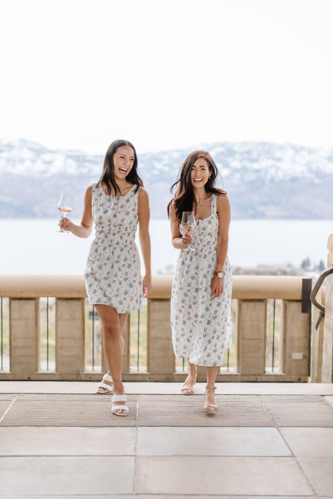 Tori and Victoria walking in a short and long floral dress at a winery