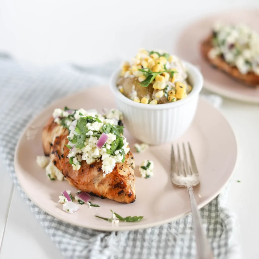 feta salsa on grilled chicken with a side corn potato salad