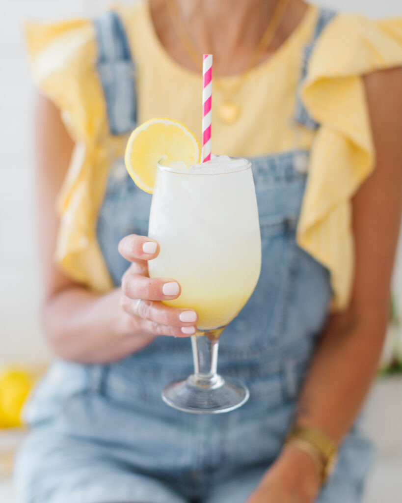 homemade lemonade in a glass with a pink straw
