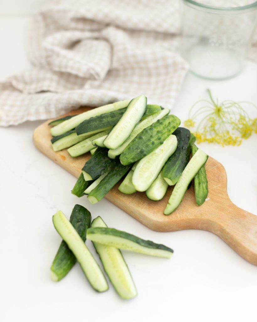 sliced cucumbers on a cutting board to use for quick dill pickles