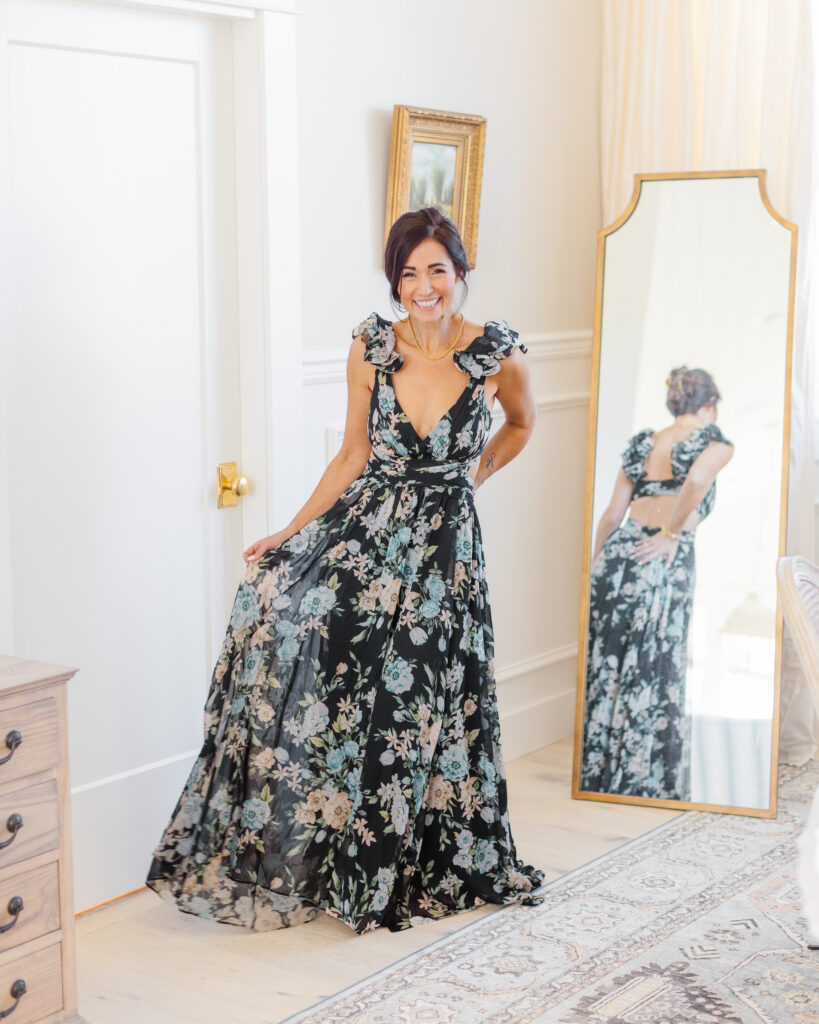 Tori in floor length black and blue floral gown