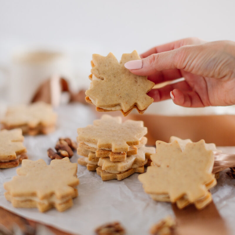 a handing holding up a Maple Cream Cookie