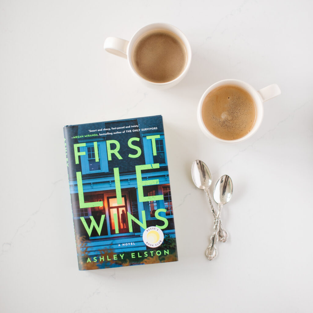 First Lie Wins book beside two cups of coffee
