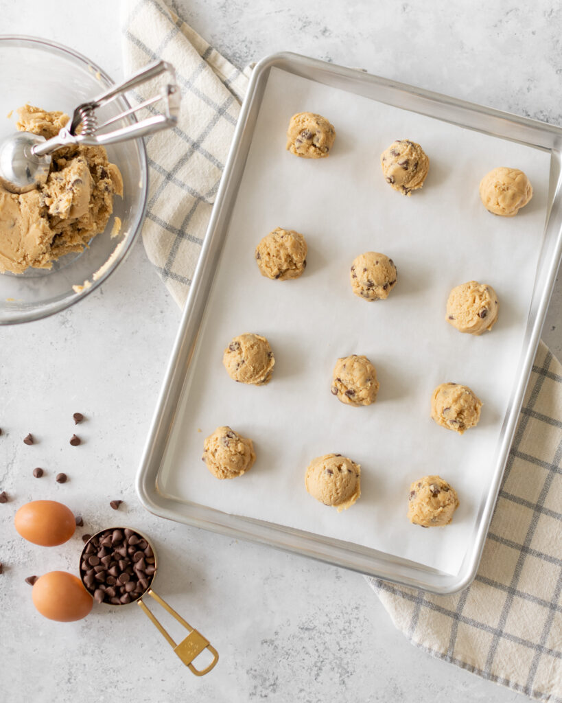 Chocolate Chip Cookie dough balls on sheet pan uncooked