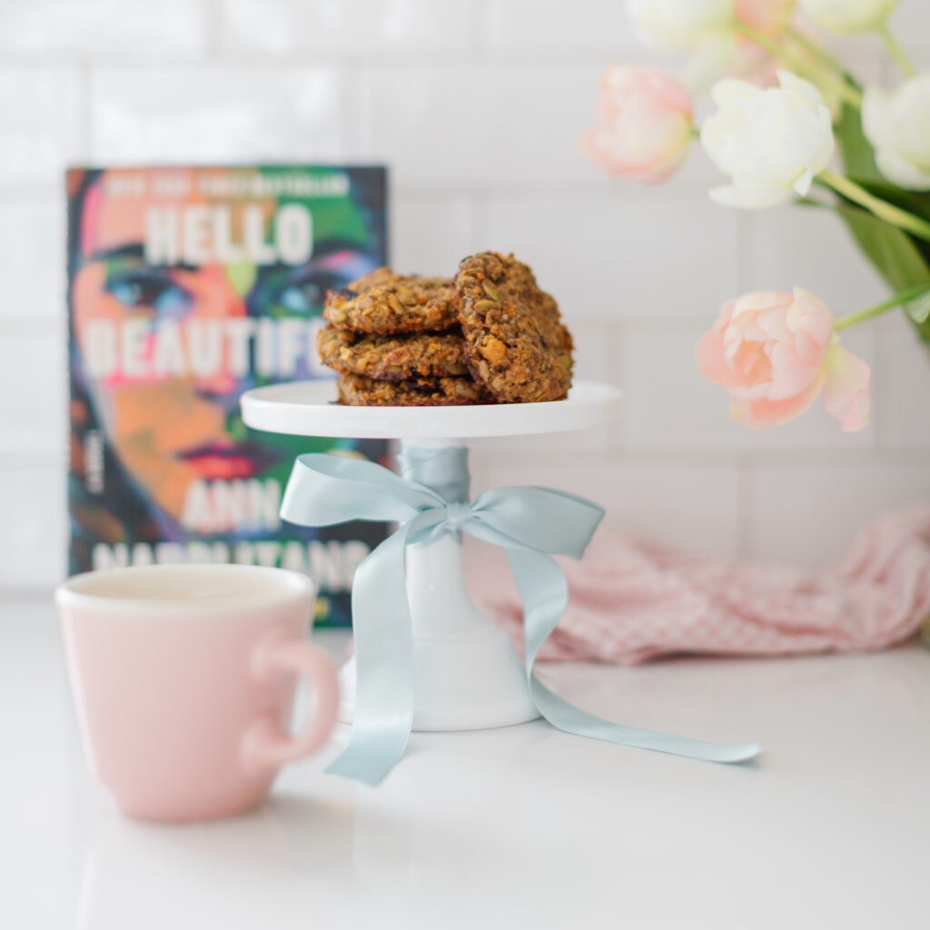 a stack of Hello Beautiful Cookies on a white cake stand, tied with a bow