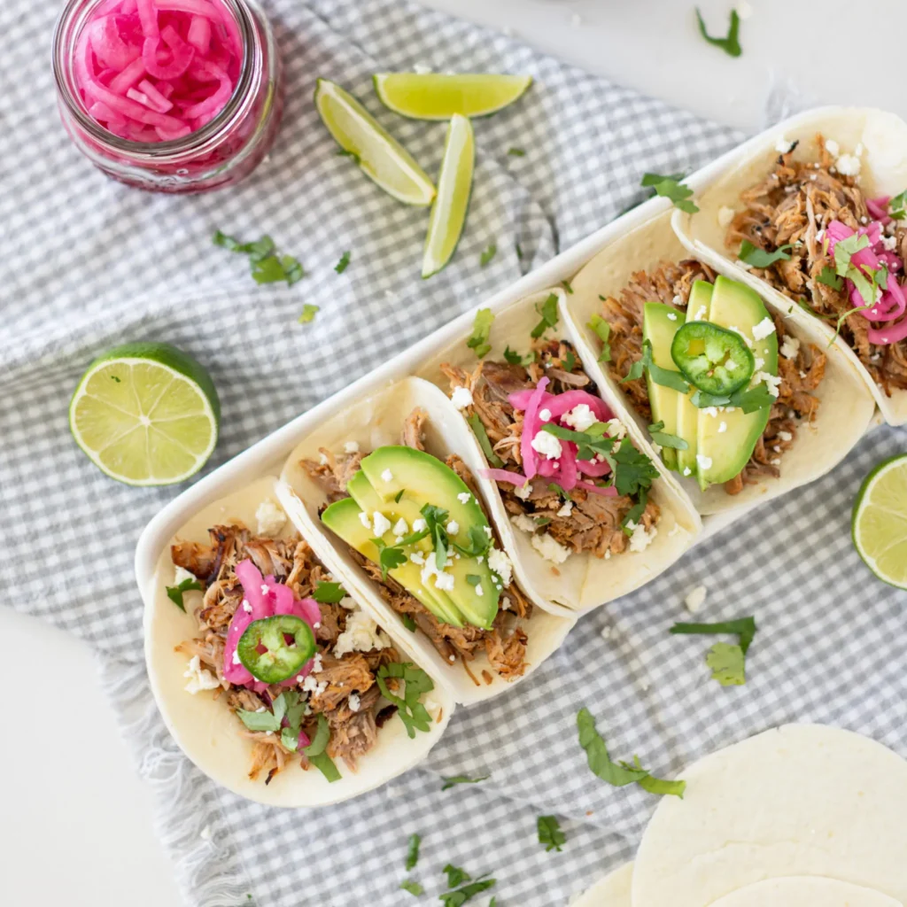 Fraiche Table Slow Cooker Carnitas topped with avocado and picked red onion