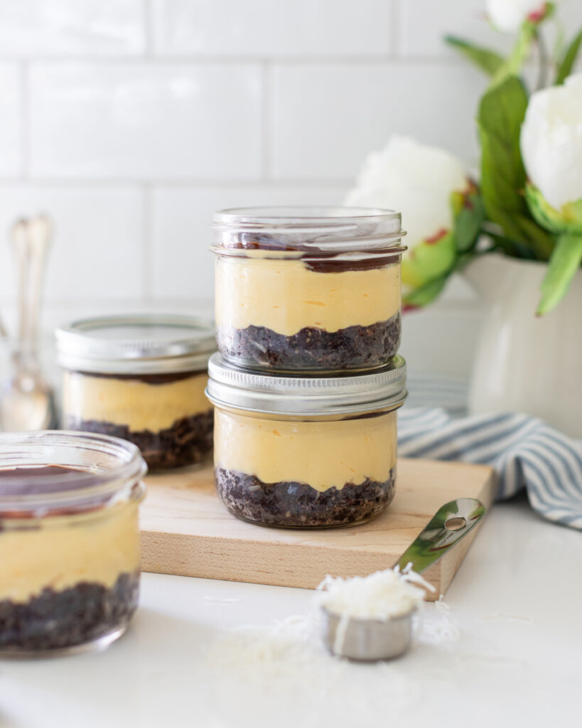 No-Bake Nanaimo Bar Cheesecake Jars stacked on counter