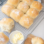 Perfect White Buns with butter on a cooling rack