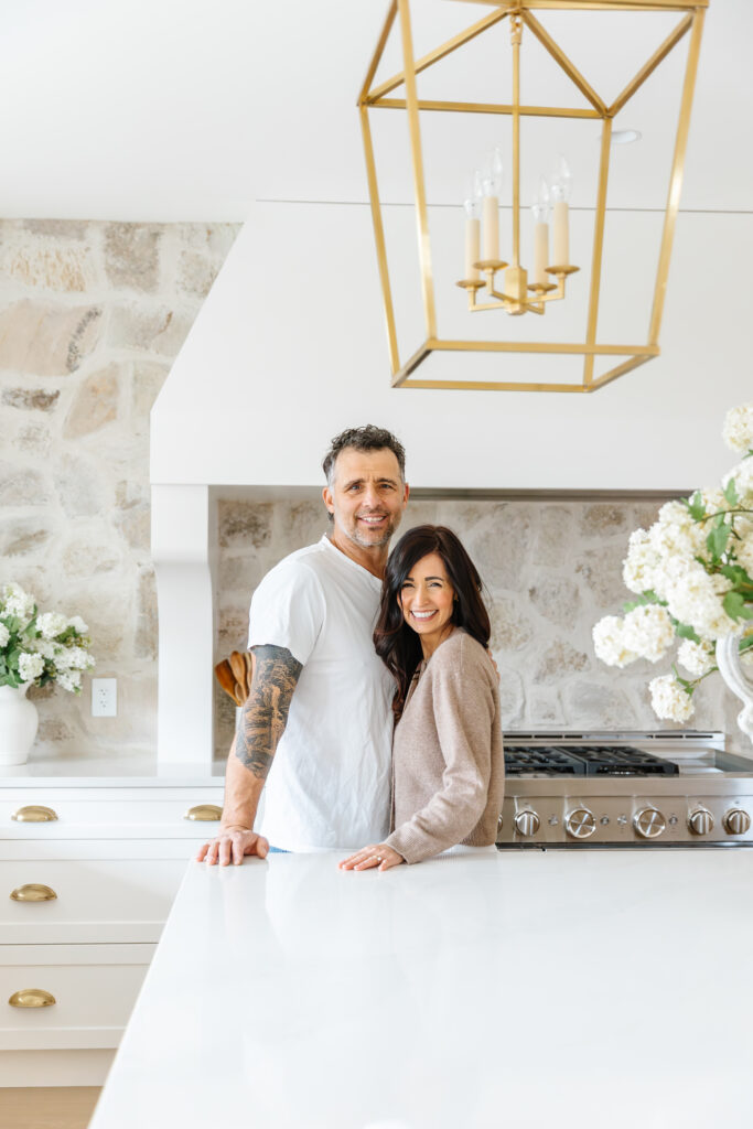 Tori and Charles in front of their French Country Stone Kitchen Backsplash