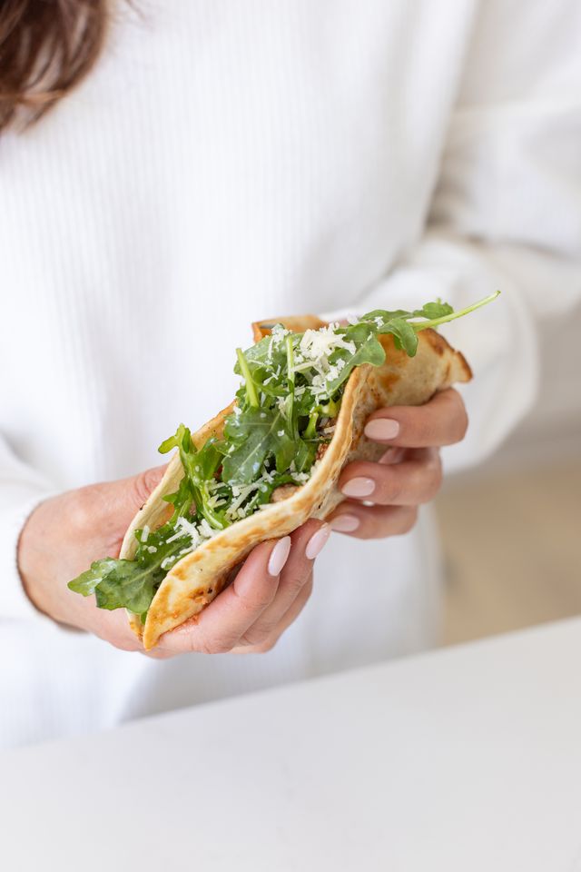hand holding a Chicken Parm Smash Tacos