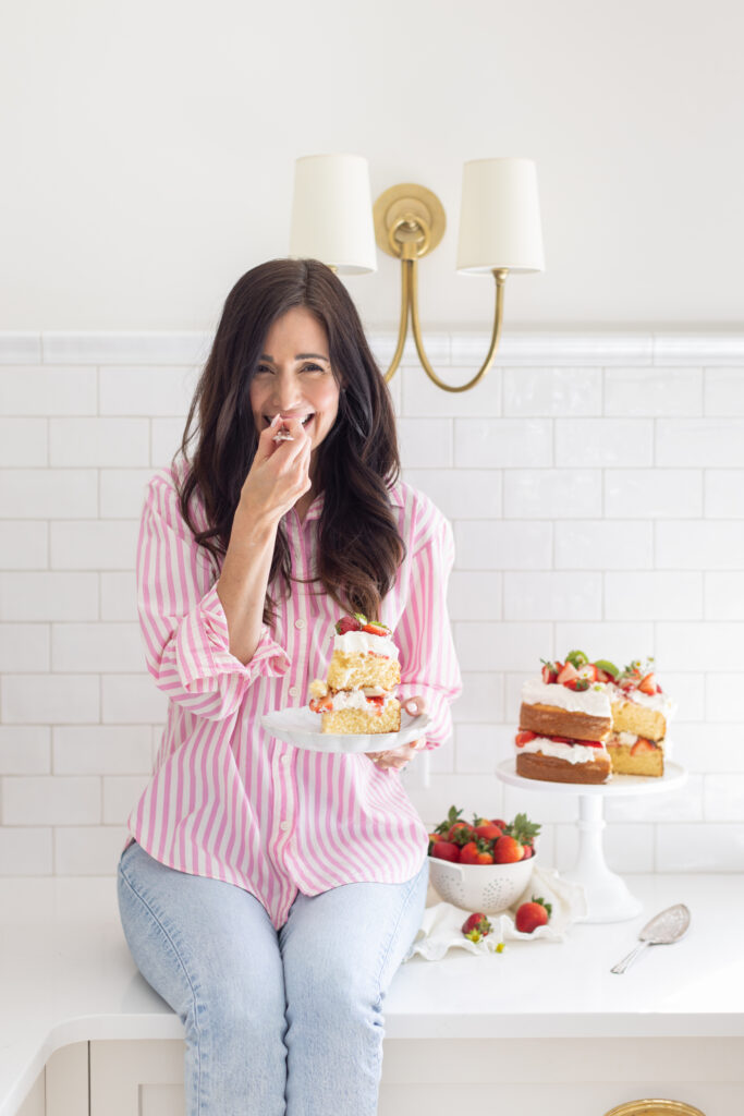 Tori biting a piece of Strawberry Shortcake Cake