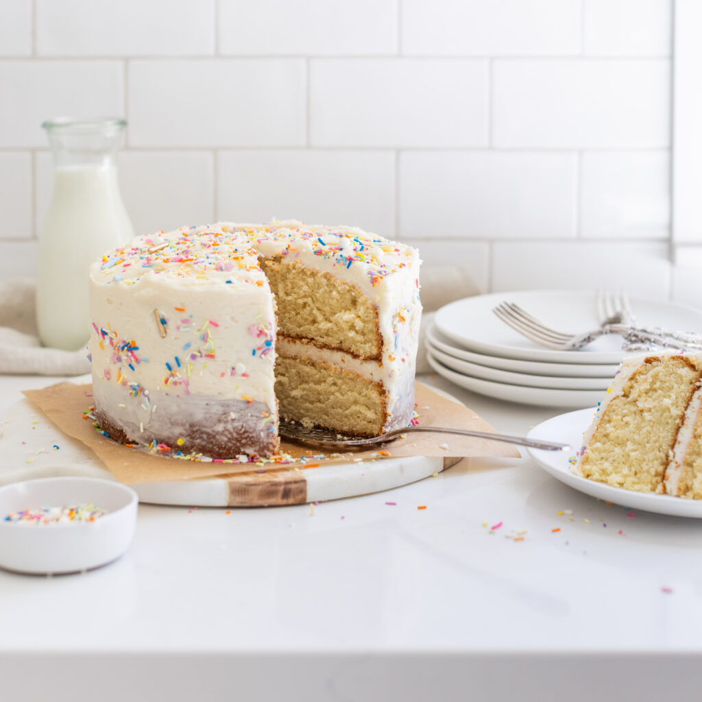 Perfect vanilla cake decorated with colourful sprinkles on top