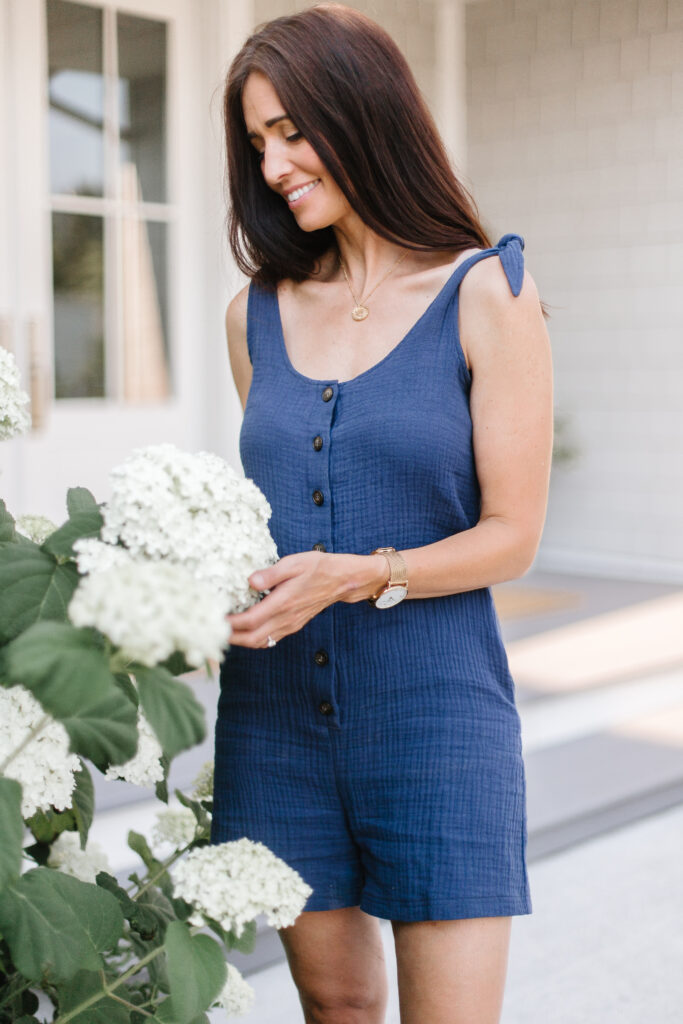 Tori smiling while pruning Incrediball hydrangeas in the garden