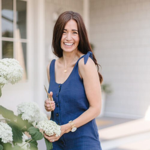 Tori trimming white Incrediball hydrangeas in the garden