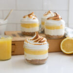 Lemon Meringue Cheesecake Jars topped with toasted meringue and lemon curd served in glass jars