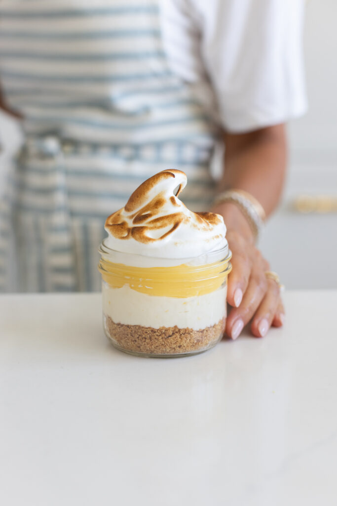 Lemon Meringue Cheesecake Jars topped with toasted meringue and lemon curd served in glass jars