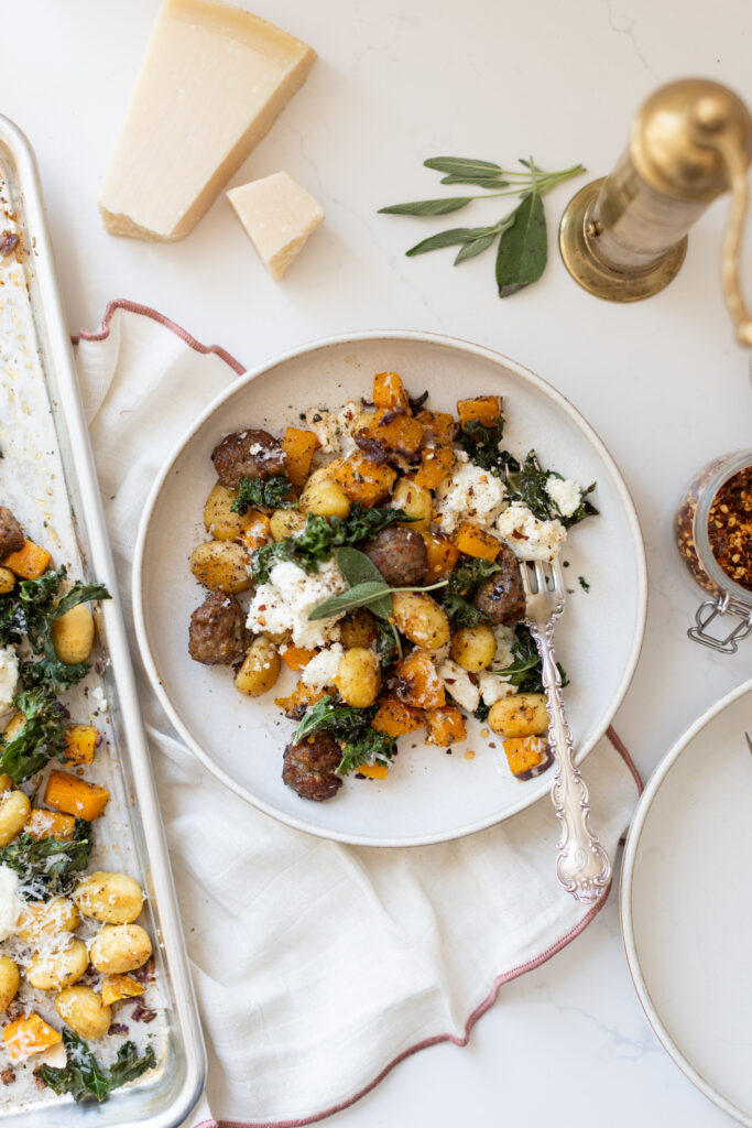 Squash & Italian Sausage Gnocchi On A White Plate
