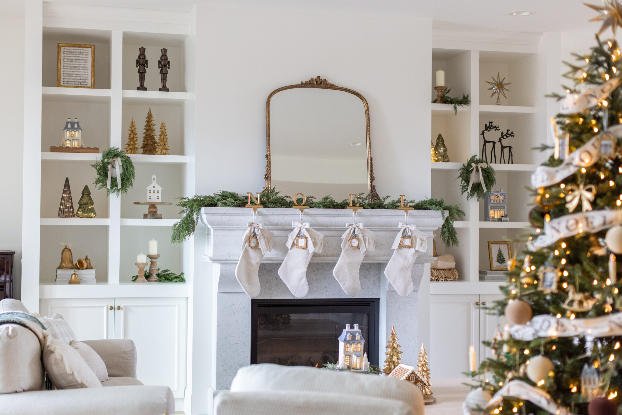 Living room decorated with the Fraîche Holiday Collection at Walmart, featuring a fireplace with stockings and garland