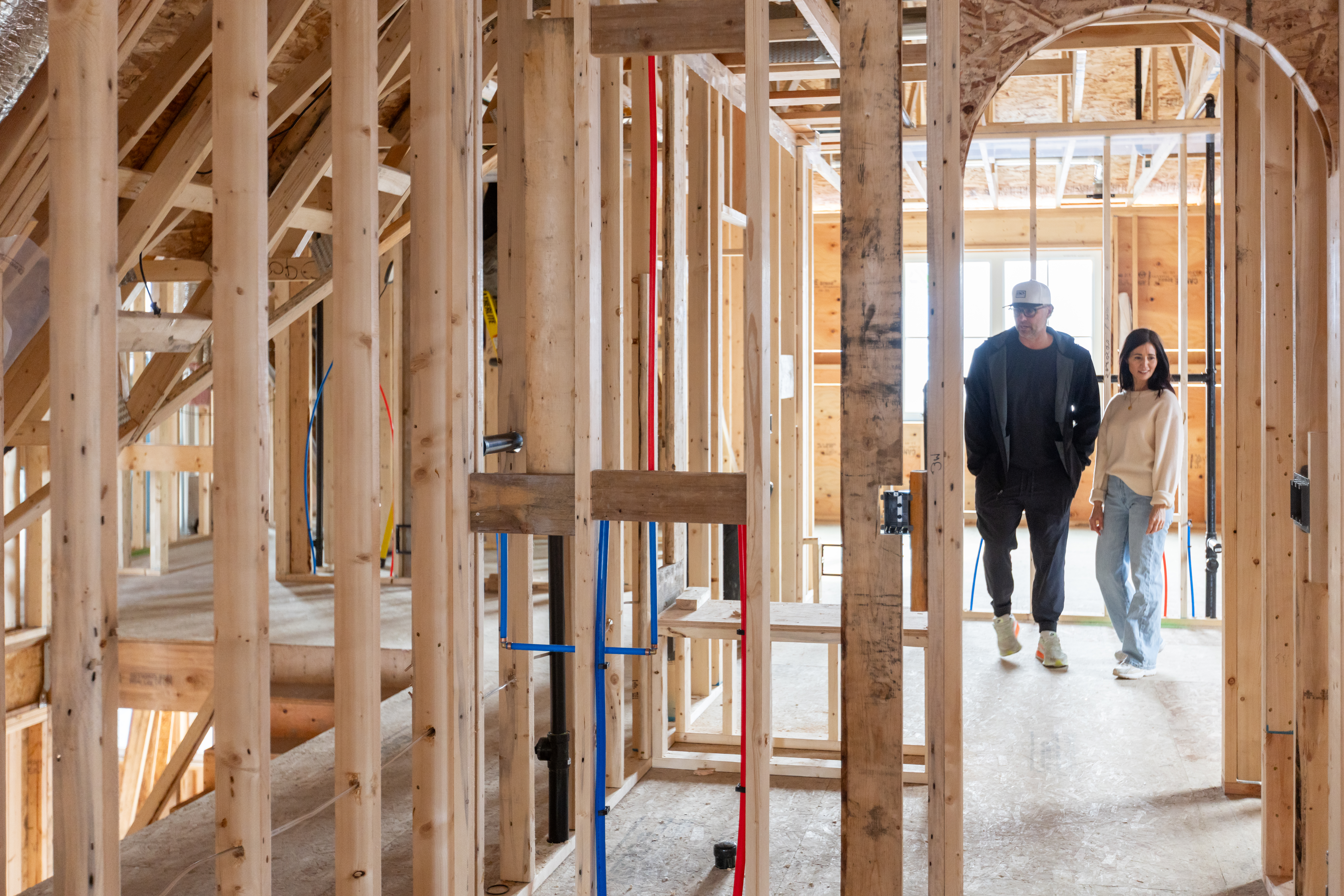 Tori and Charles, her builder and husband, walking through new build