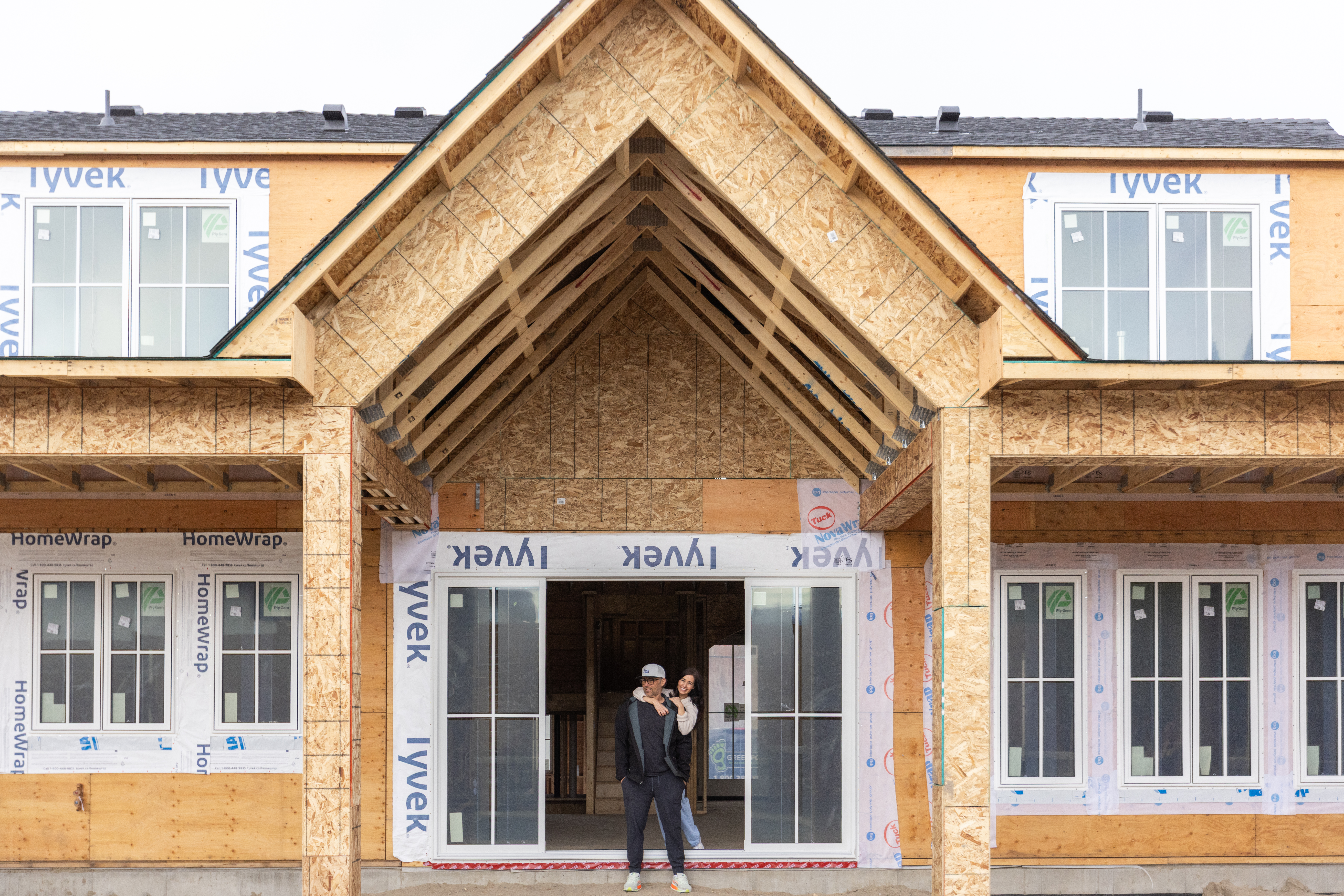 Tori and Charles - her husband and builder, outside newest build