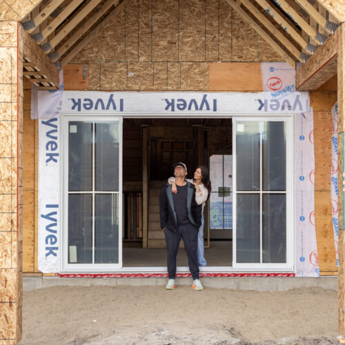Tori and Charles - her husband and builder, outside newest build