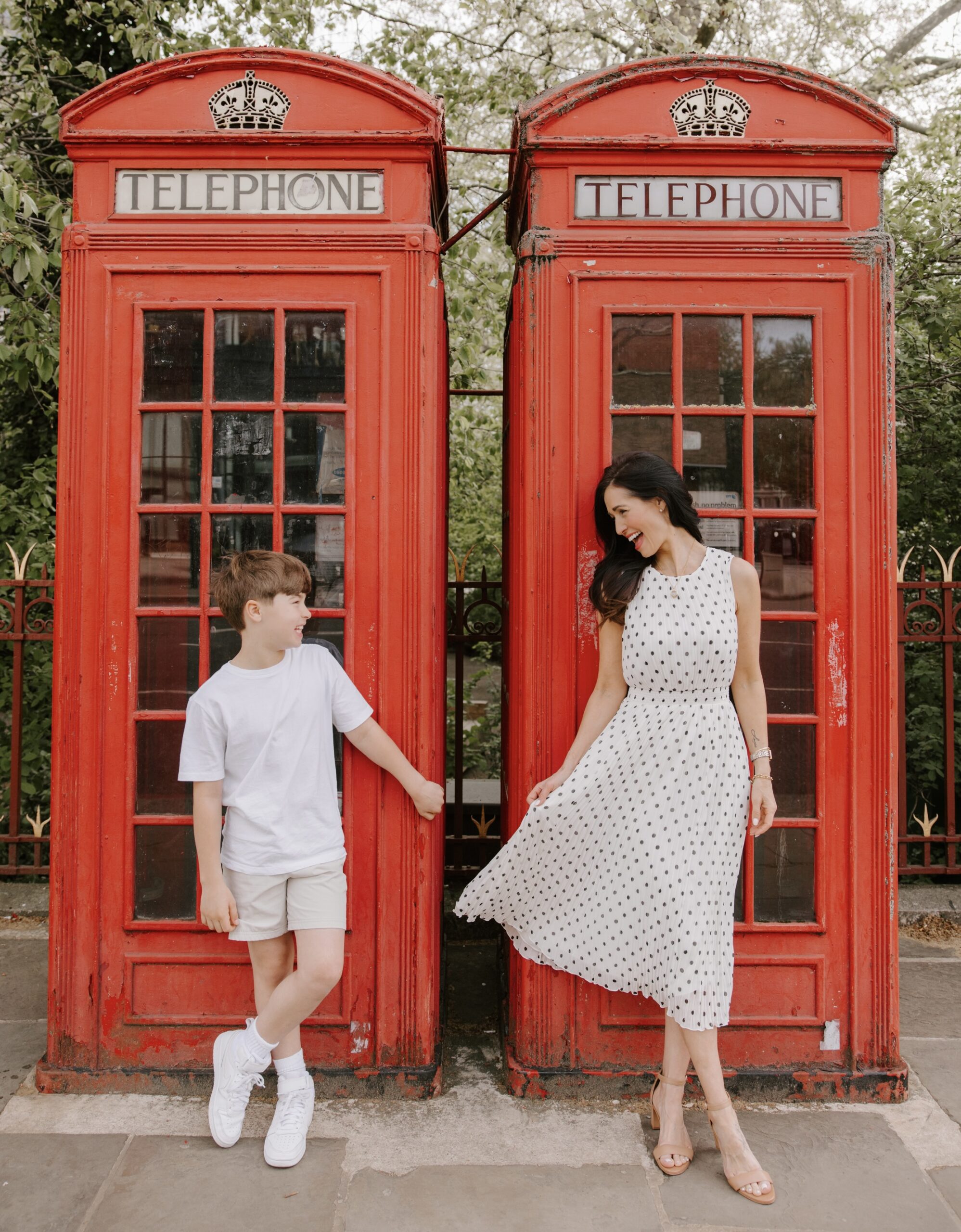 Tori and Max in London in front of iconic red telephone booth
